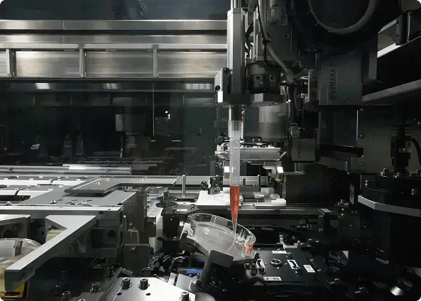 NPi-11 robotic arms performing automated cell culture pipetting inside the enclosed biosafe workspace