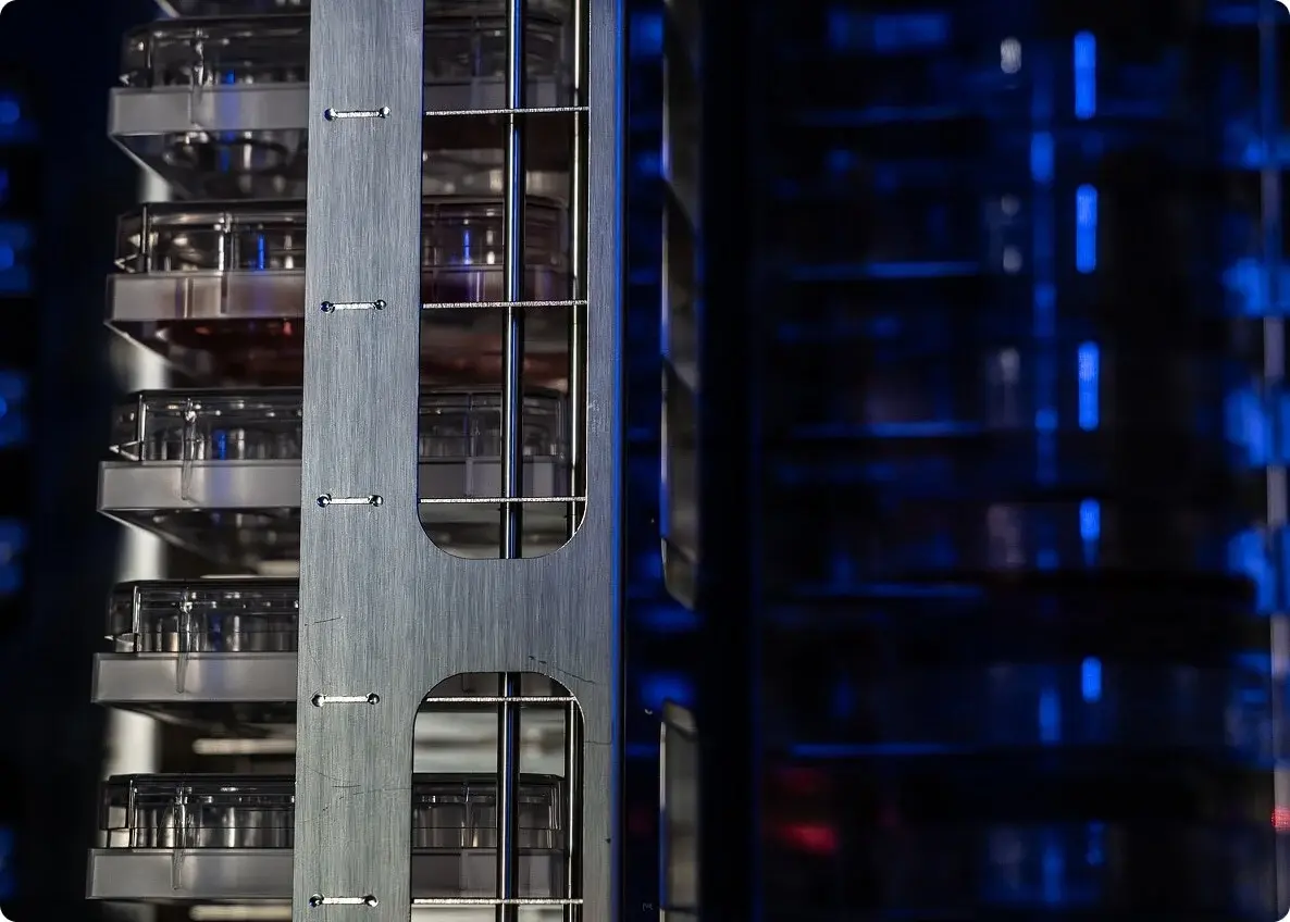 Interior of the Panasonic NPi-11 automated cell culture system showing the enclosed incubator and robotic workspace with blue LED illumination